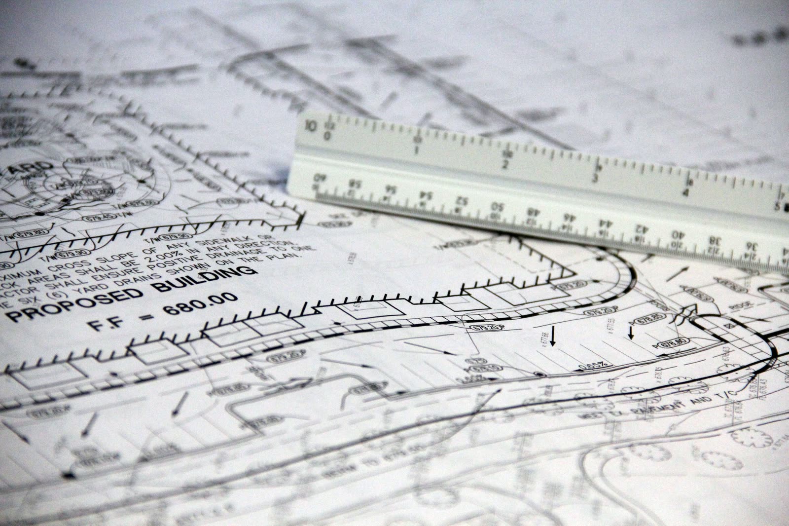 Construction drawings with a scale rule laid across them.